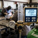 Welding gas flow rate calculator showing CFH and L/min settings on regulator