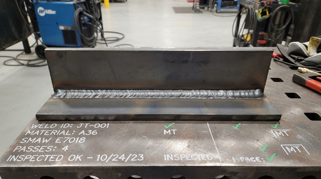 Clean completed multipass stick weld on thick structural steel plate.